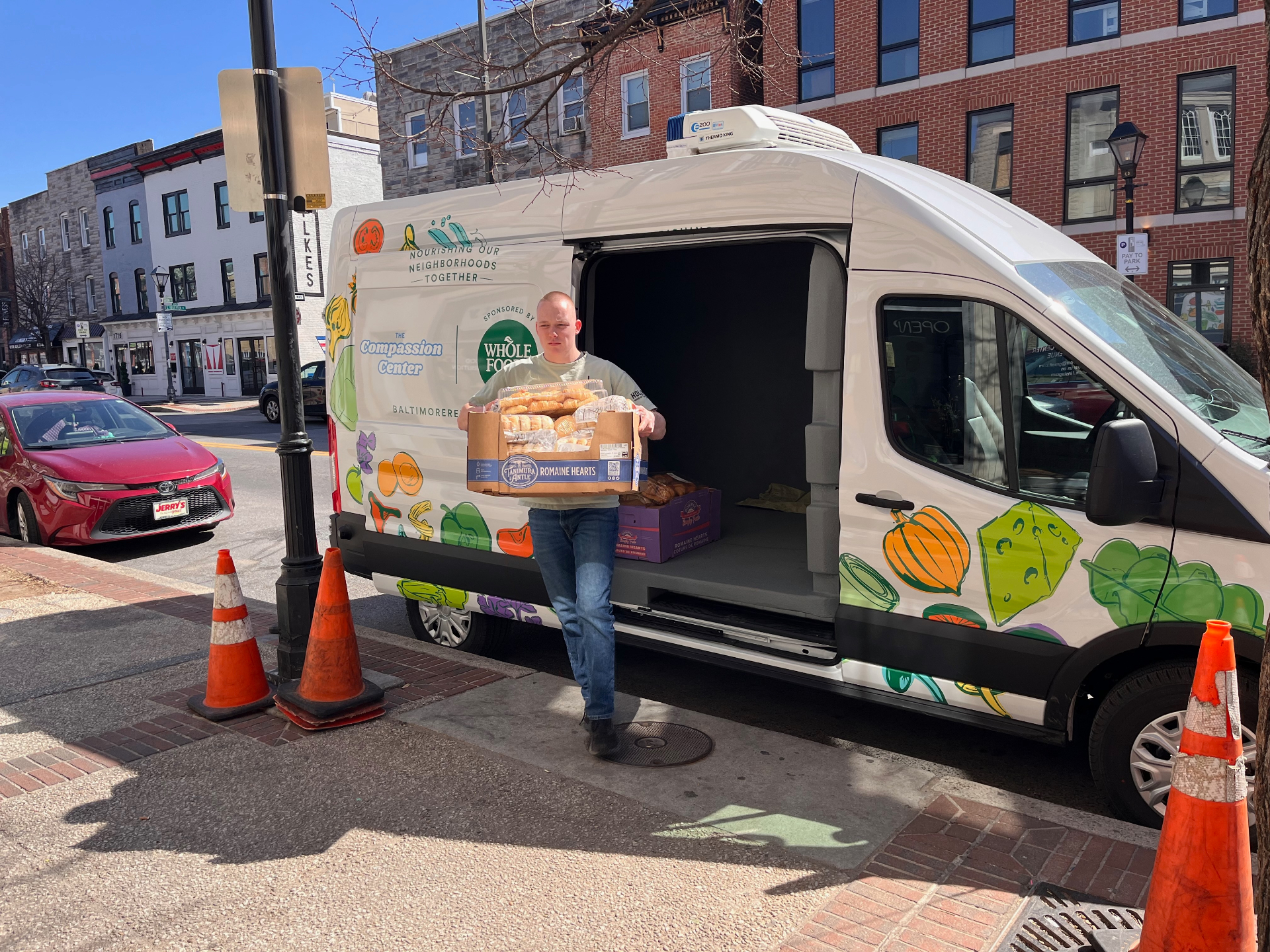 Volunteer delivering food from a distribution truck