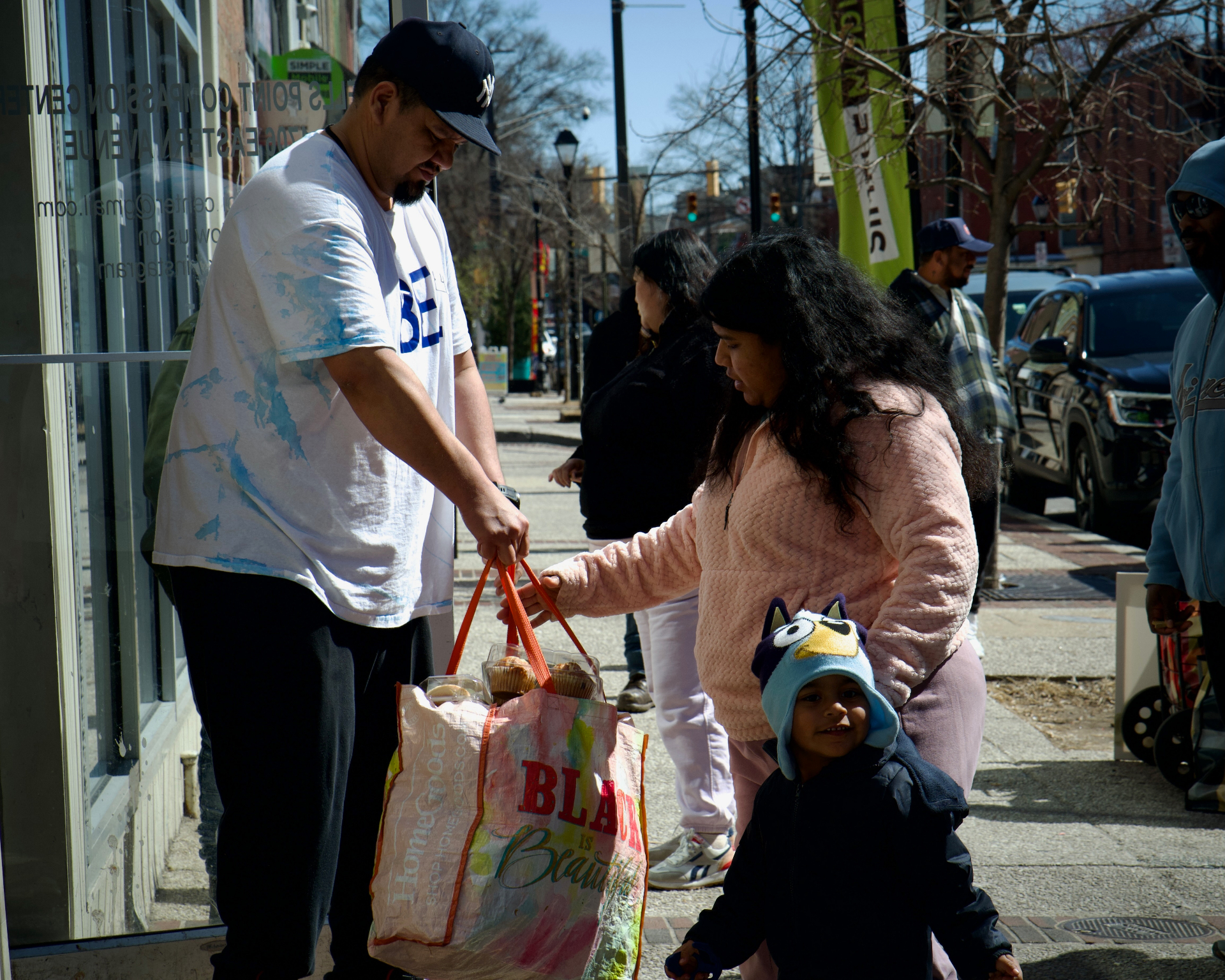 Volunteer helping a family with groceries